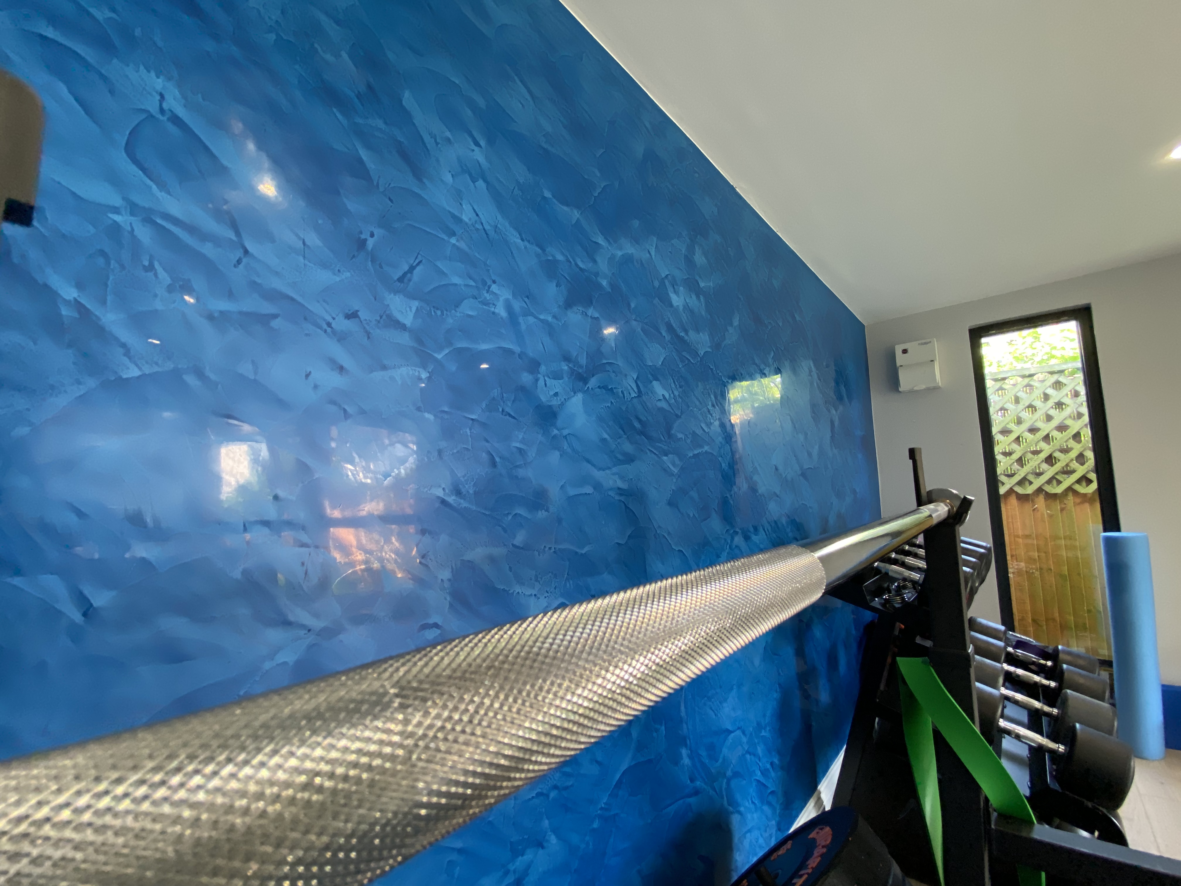 blue venetian polished plaster feature wall in home gym garden room and yoga studio in high barnet london
